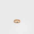 Gold ring on a light gray background
